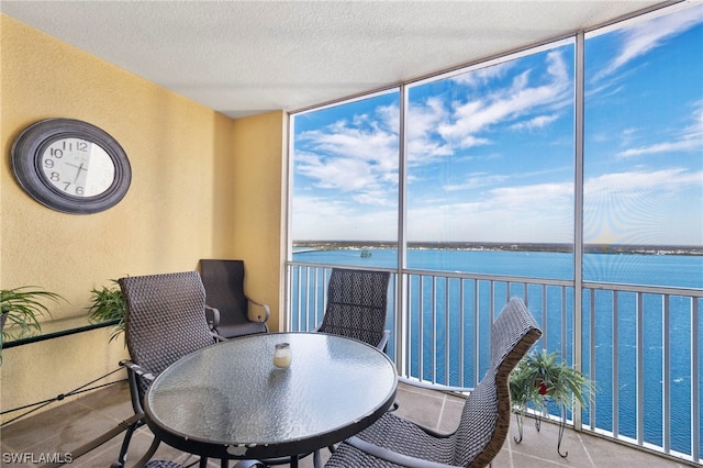 sunroom / solarium with a water view