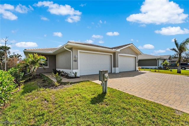 ranch-style house with a garage and a front lawn