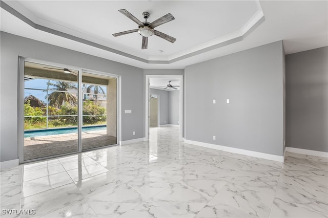 unfurnished room with a tray ceiling and ceiling fan