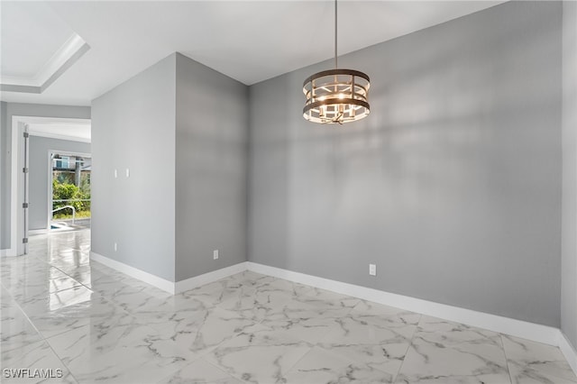 unfurnished dining area featuring crown molding and an inviting chandelier