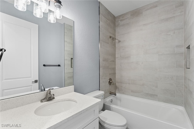 full bathroom with vanity, toilet, and tiled shower / bath