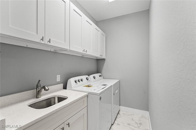 laundry area with washer and clothes dryer, cabinets, and sink