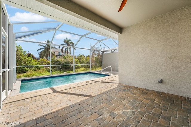 view of pool with a lanai, a patio area, and ceiling fan