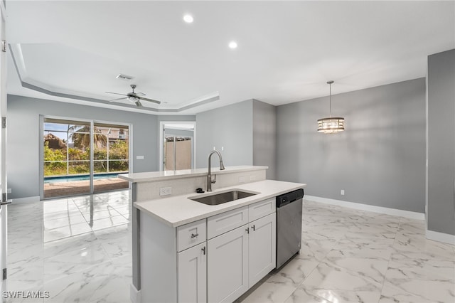 kitchen with dishwasher, sink, decorative light fixtures, a kitchen island with sink, and ceiling fan with notable chandelier