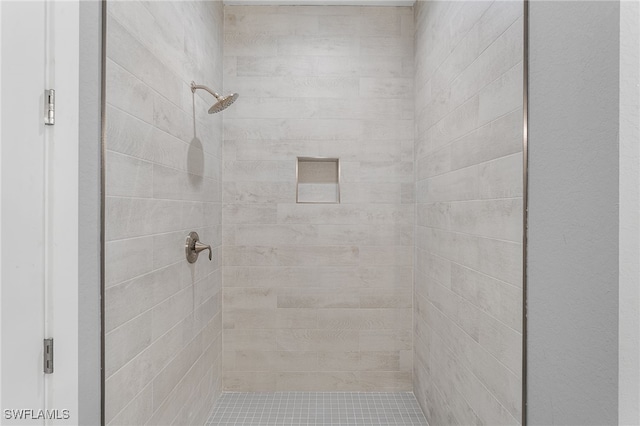 bathroom with a tile shower