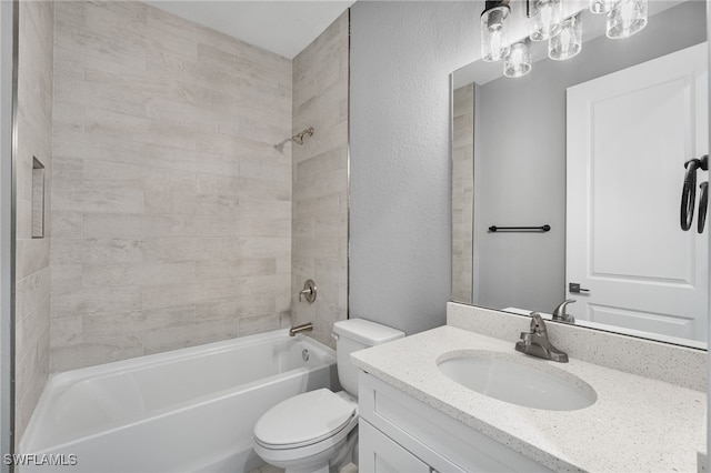 full bathroom with tiled shower / bath combo, toilet, and vanity