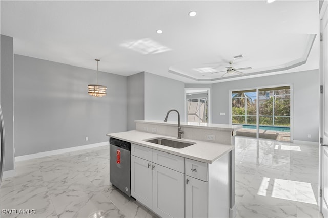 kitchen featuring sink, decorative light fixtures, a center island with sink, dishwasher, and white cabinetry