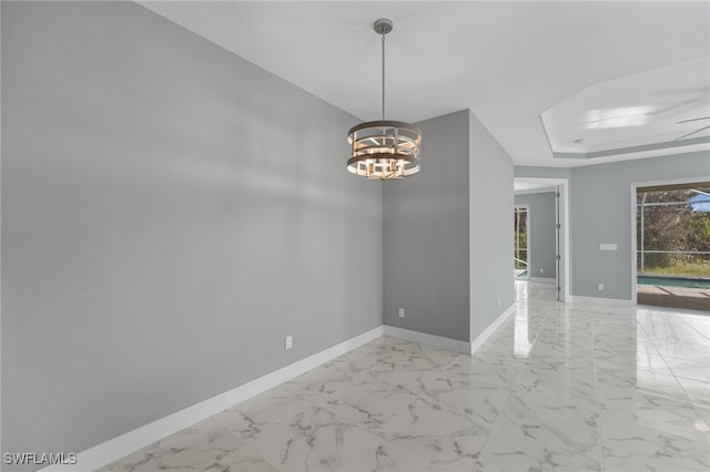 empty room featuring ceiling fan with notable chandelier