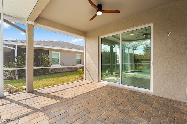 view of patio / terrace featuring a lanai and ceiling fan