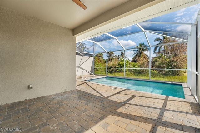 view of pool featuring a lanai, ceiling fan, and a patio