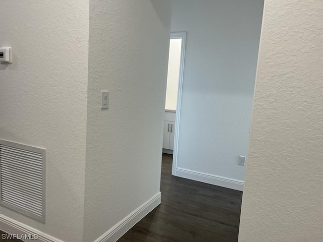 hall with dark hardwood / wood-style flooring