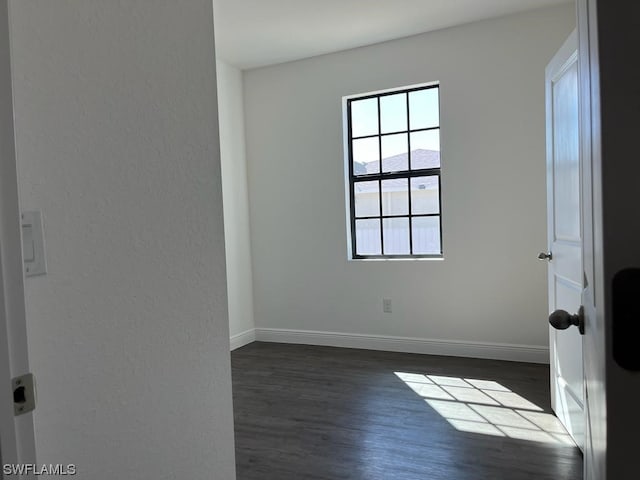 empty room featuring dark wood-type flooring