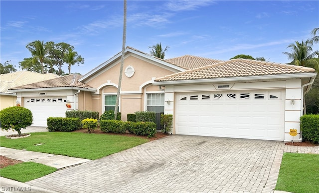 view of front of home with a front lawn and a garage