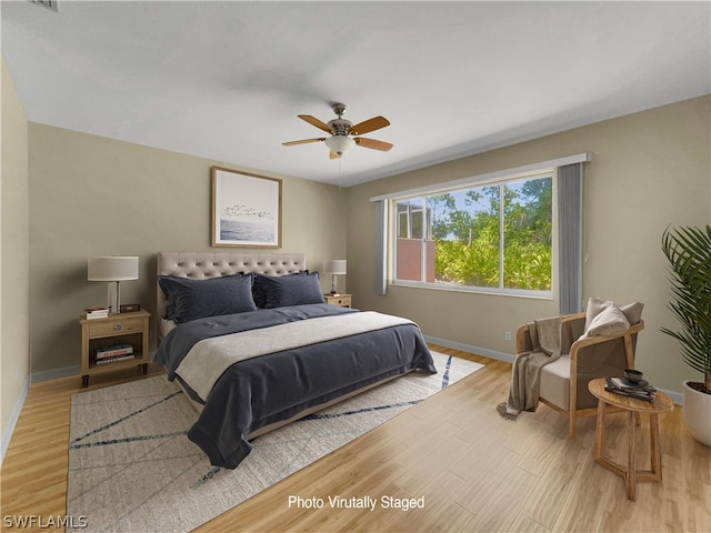 bedroom with light hardwood / wood-style flooring and ceiling fan