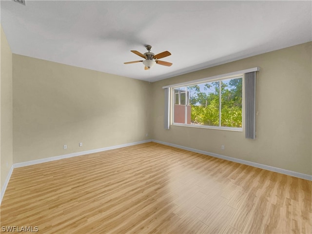 spare room featuring light hardwood / wood-style floors and ceiling fan