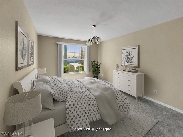 bedroom featuring carpet flooring and a chandelier