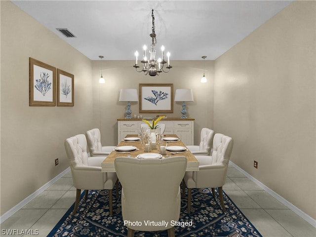 dining room featuring a notable chandelier and light tile patterned floors