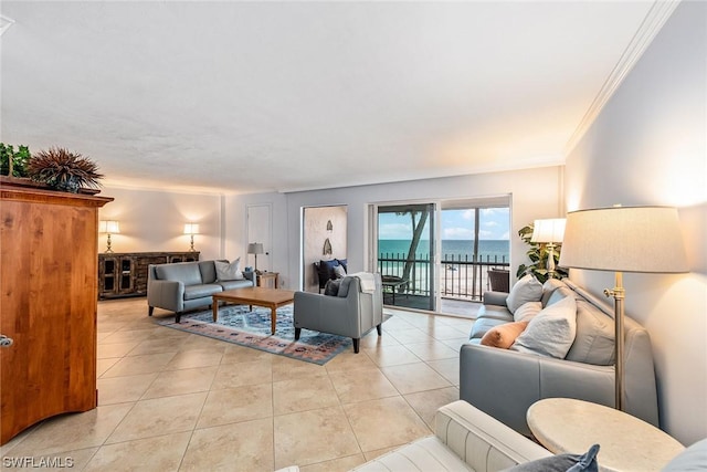 living room with crown molding, a water view, and light tile patterned floors