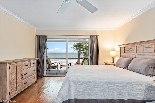 bedroom featuring a water view, crown molding, light hardwood / wood-style flooring, ceiling fan, and access to exterior