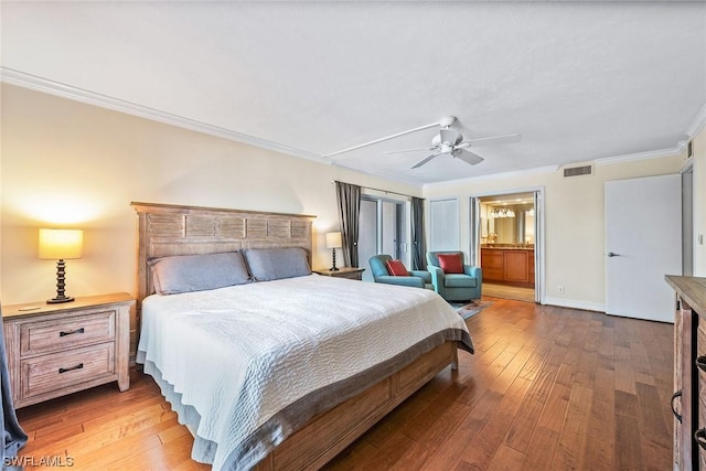 bedroom featuring hardwood / wood-style flooring, ceiling fan, ornamental molding, and connected bathroom