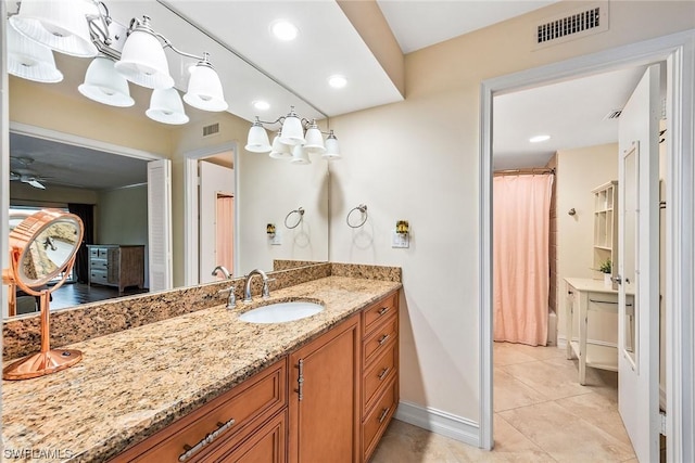 bathroom with tile patterned flooring, vanity, and shower / bath combo with shower curtain