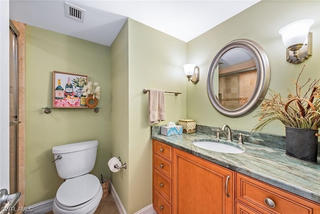 bathroom featuring vanity, tile patterned floors, and toilet