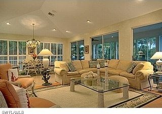 interior space featuring a chandelier and vaulted ceiling