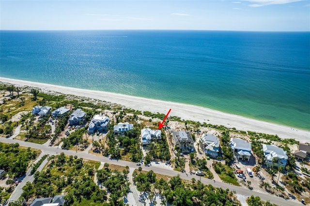 birds eye view of property with a water view and a view of the beach