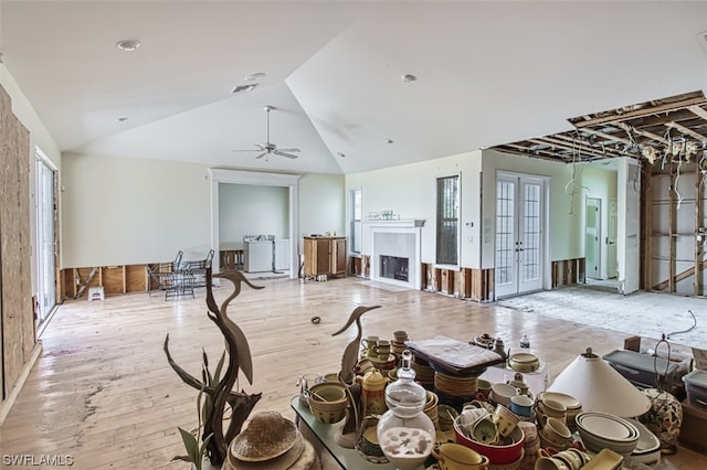 interior space featuring french doors, light hardwood / wood-style floors, ceiling fan, and lofted ceiling