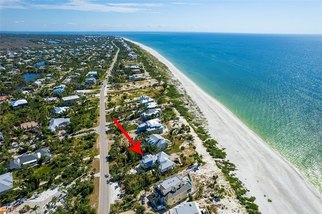 bird's eye view with a water view and a view of the beach