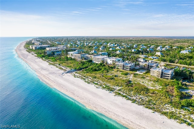 drone / aerial view featuring a beach view and a water view