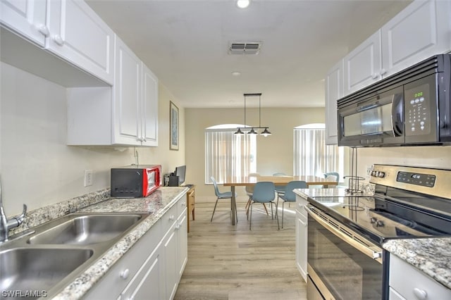 kitchen featuring decorative light fixtures, electric range, white cabinetry, light wood-type flooring, and sink