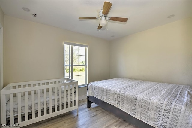 bedroom with ceiling fan and light wood-type flooring