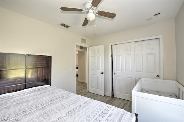 bedroom with a closet, ceiling fan, and light wood-type flooring