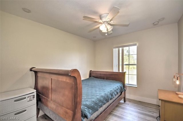 bedroom featuring ceiling fan and light hardwood / wood-style flooring