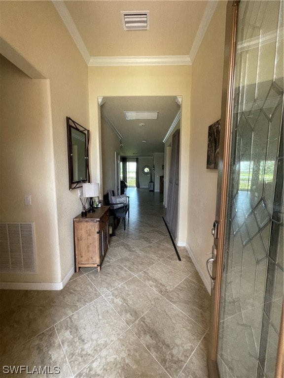 hall featuring crown molding and light tile floors