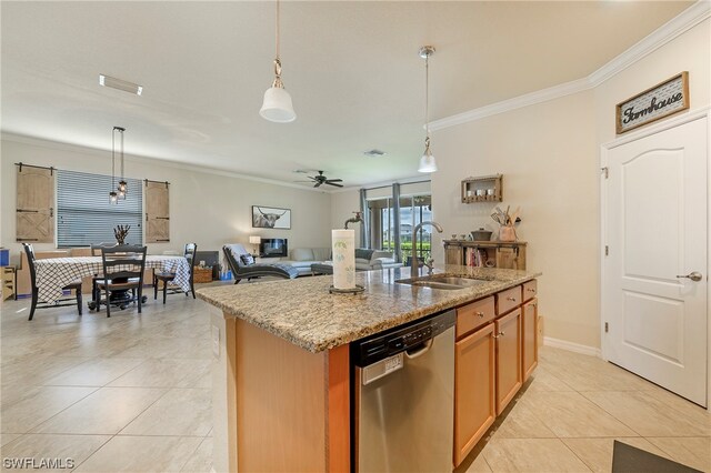 kitchen with hanging light fixtures, dishwasher, sink, and an island with sink