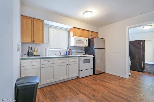 2147 Washington Ave, Naples, FL 34112 - kitchen featuring white appliances, white cabinetry, sink, and light hardwood / wood-style flooring