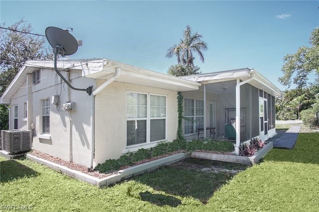 2147 Washington Ave, Naples, FL 34112 - rear view of house featuring central AC unit and a lawn