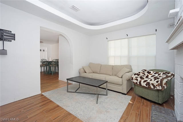 2147 Washington Ave, Naples, FL 34112 - living room featuring a raised ceiling and dark wood-type flooring