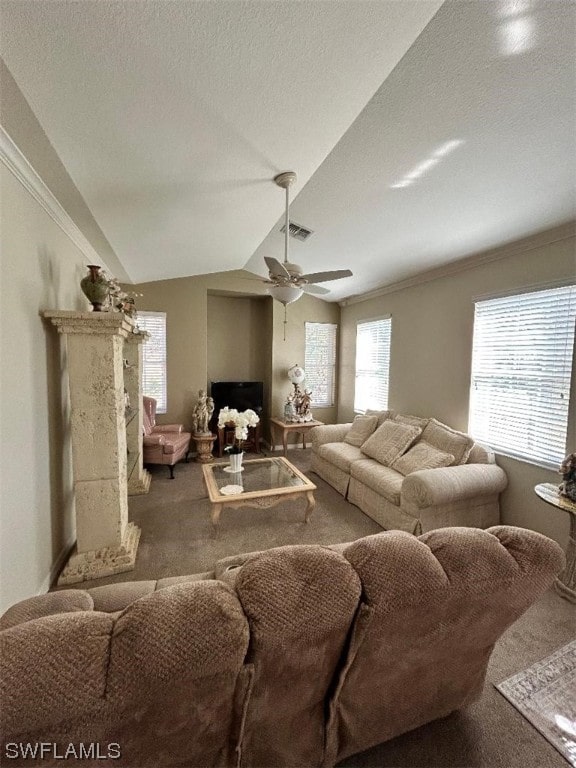 carpeted living room featuring a textured ceiling, lofted ceiling, ceiling fan, and a high end fireplace