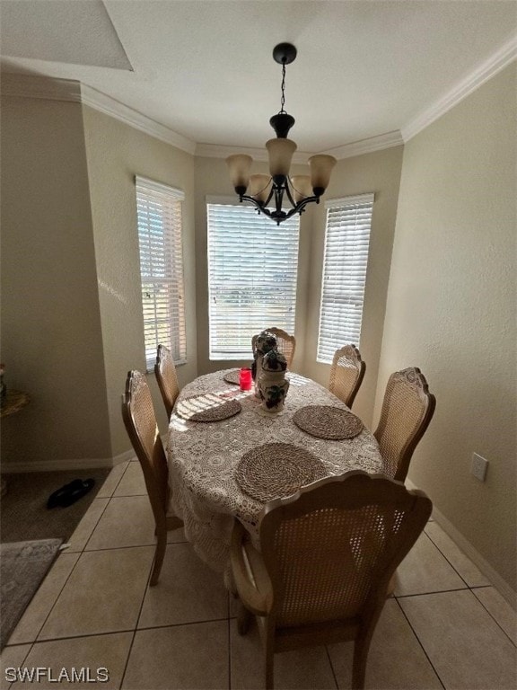 tiled dining space with a notable chandelier, a healthy amount of sunlight, and crown molding