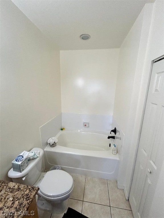 bathroom featuring a bathing tub, toilet, tile flooring, vanity, and a textured ceiling