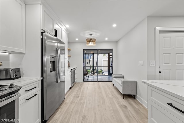 kitchen with appliances with stainless steel finishes, light hardwood / wood-style flooring, light stone countertops, beverage cooler, and white cabinetry