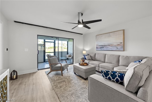 living room featuring ceiling fan and light hardwood / wood-style flooring