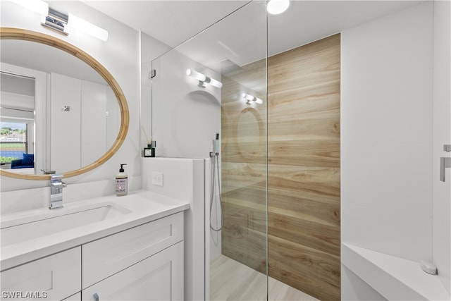 bathroom featuring oversized vanity and a shower with door