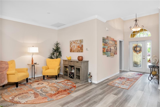 foyer entrance with crown molding and hardwood / wood-style flooring