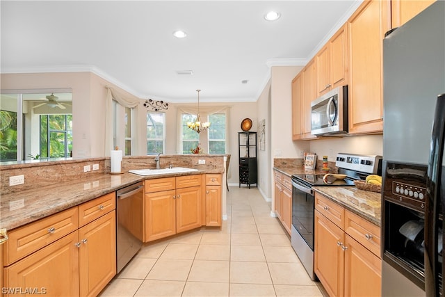 kitchen with appliances with stainless steel finishes, a healthy amount of sunlight, light stone countertops, and light tile floors