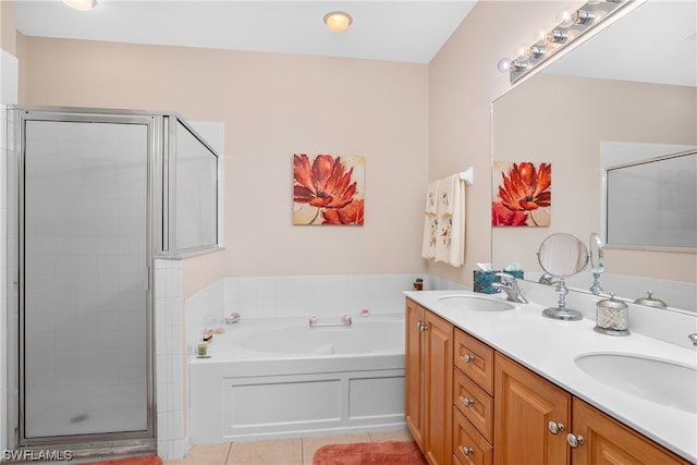 bathroom with tile floors, dual vanity, and plus walk in shower