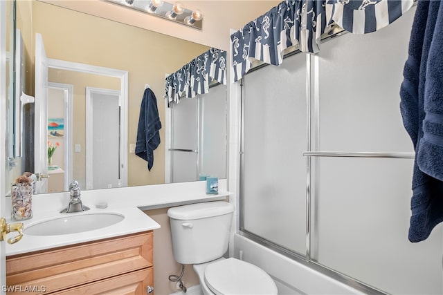 full bathroom with shower / bath combination with glass door, oversized vanity, and toilet